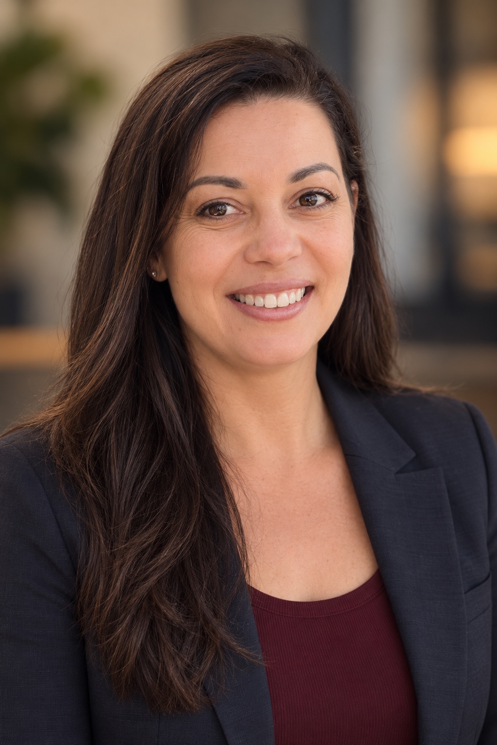 April Atwater, founder of Wren and Co., wearing a navy blazer and smiling in a professional portrait.